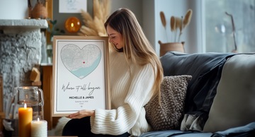 woman holding a custom heart shaped city map with the text "where it all began"