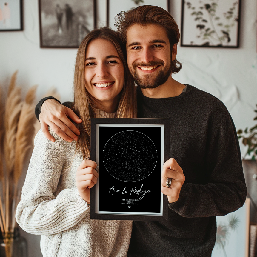 Couple holding a wall artwork of a personalized star map
